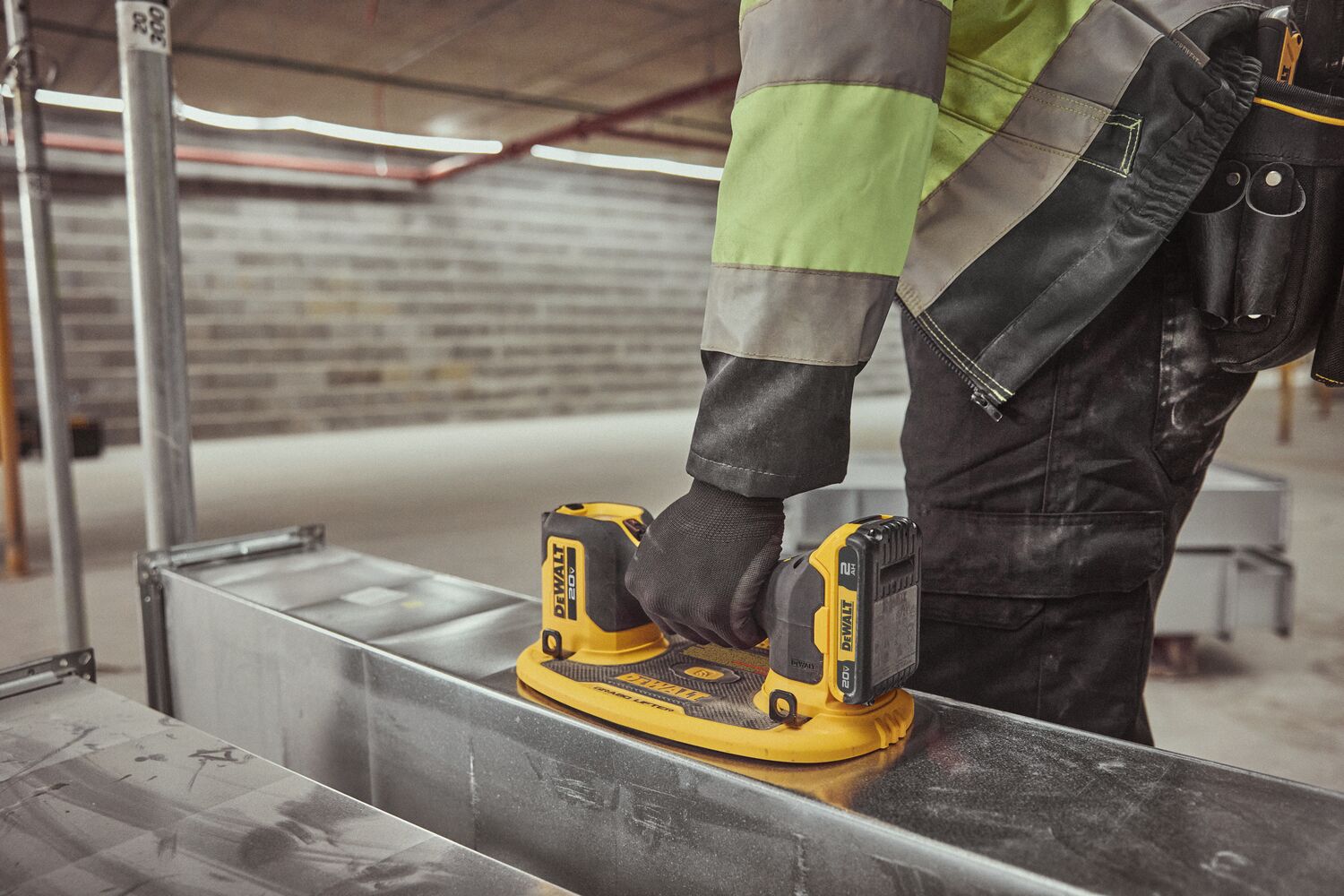 User lifting HVAC duck with DEWALT 20V MAX Grabo Lifter