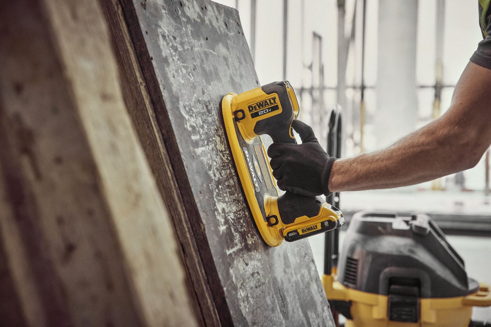 User lifting plywood with DEWALT 20V MAX Grabo Lifter 