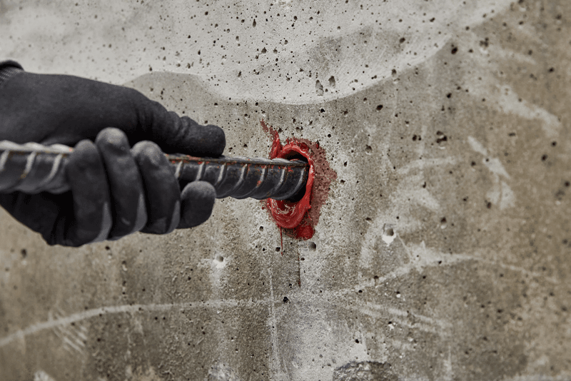 Rebar dowel being installed into concrete using Pure220+