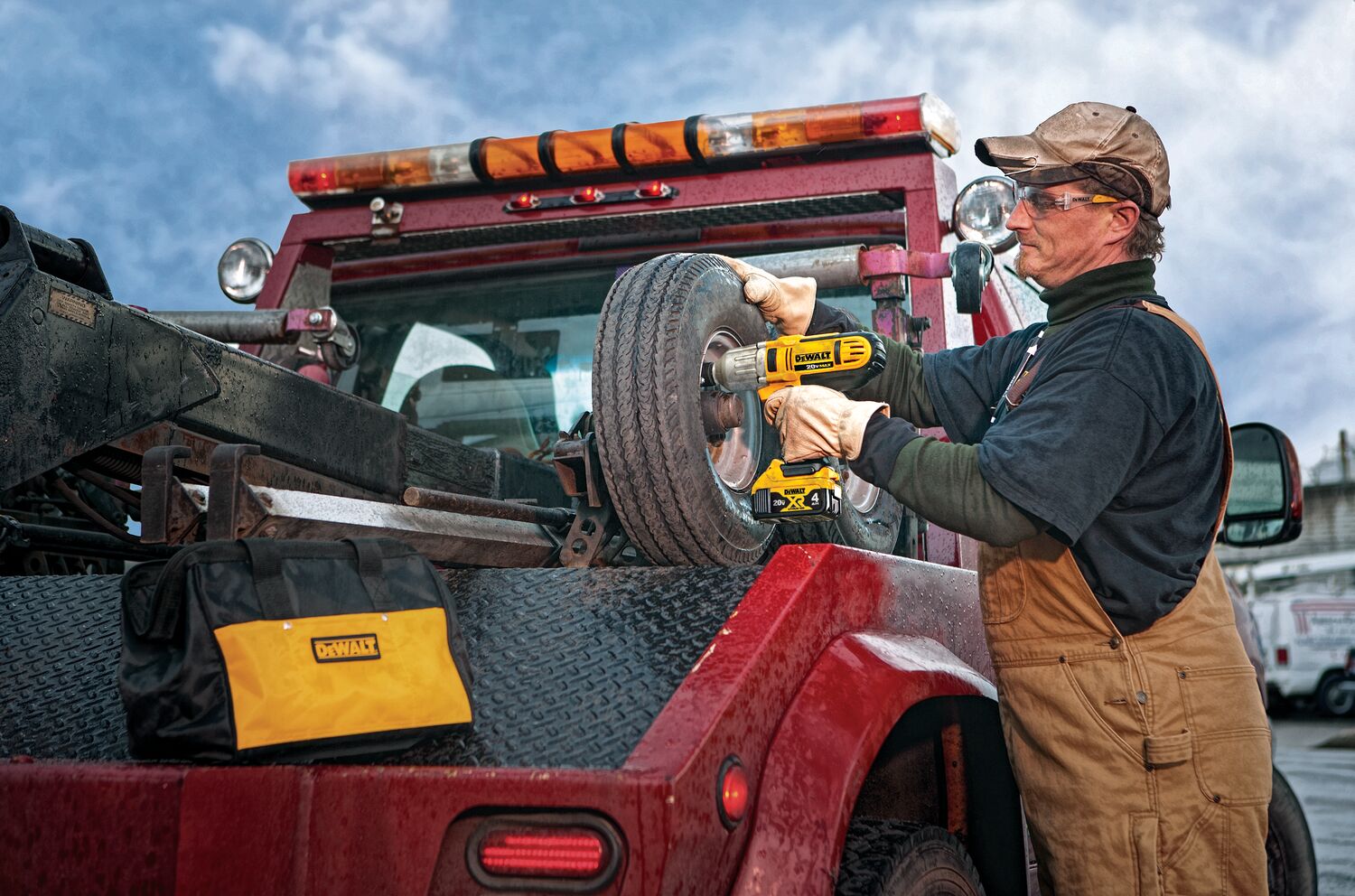 HIGH TORQUE IMPACT WRENCH being used on a tire by a person