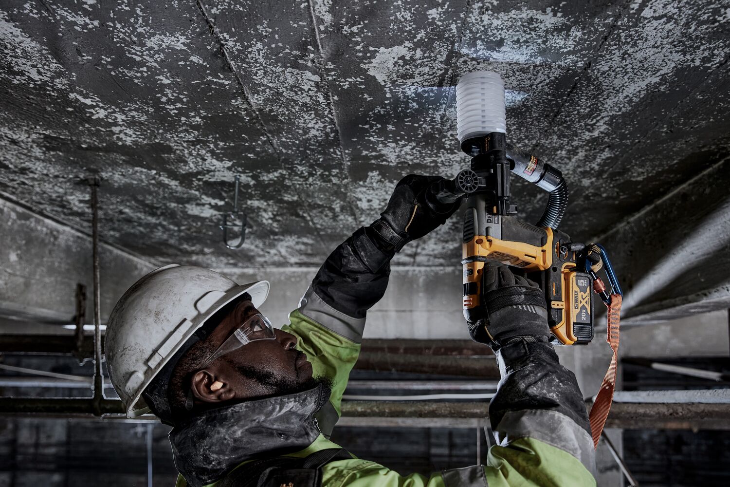 Atomic 20 volt five eighths inch brushless cordless S D S plus rotary hammer tool being used by a person.